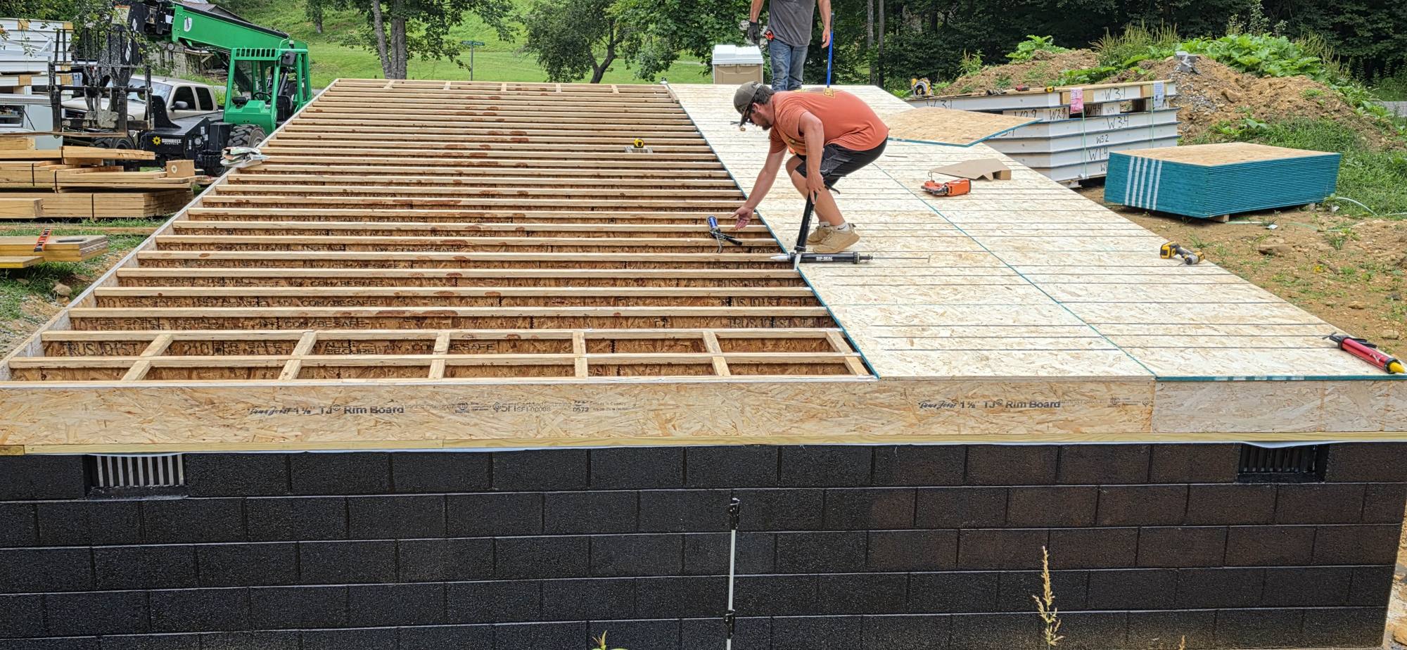 Floor joists being framed on the block foundation